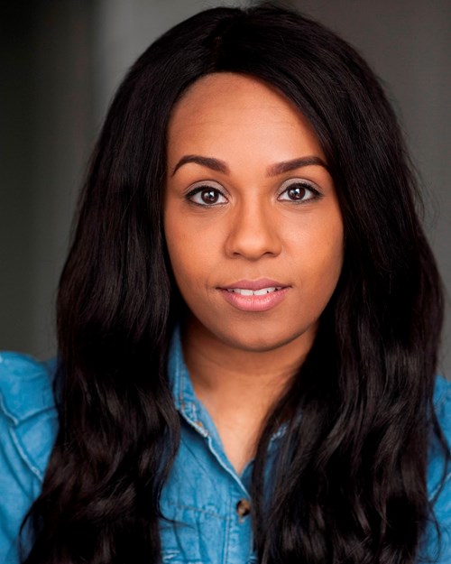 Headshot of Shorelle Hepkin. She has long black hair and wears a denim shirt, looking directly at the camera with a neutral expression. 