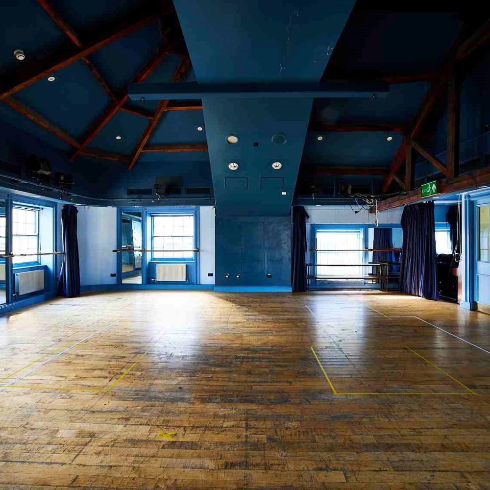 Our Attic Theatre, a large room with blue walls and wooden floor with lots of natural light. An ideal space for rehearsals and workshops.